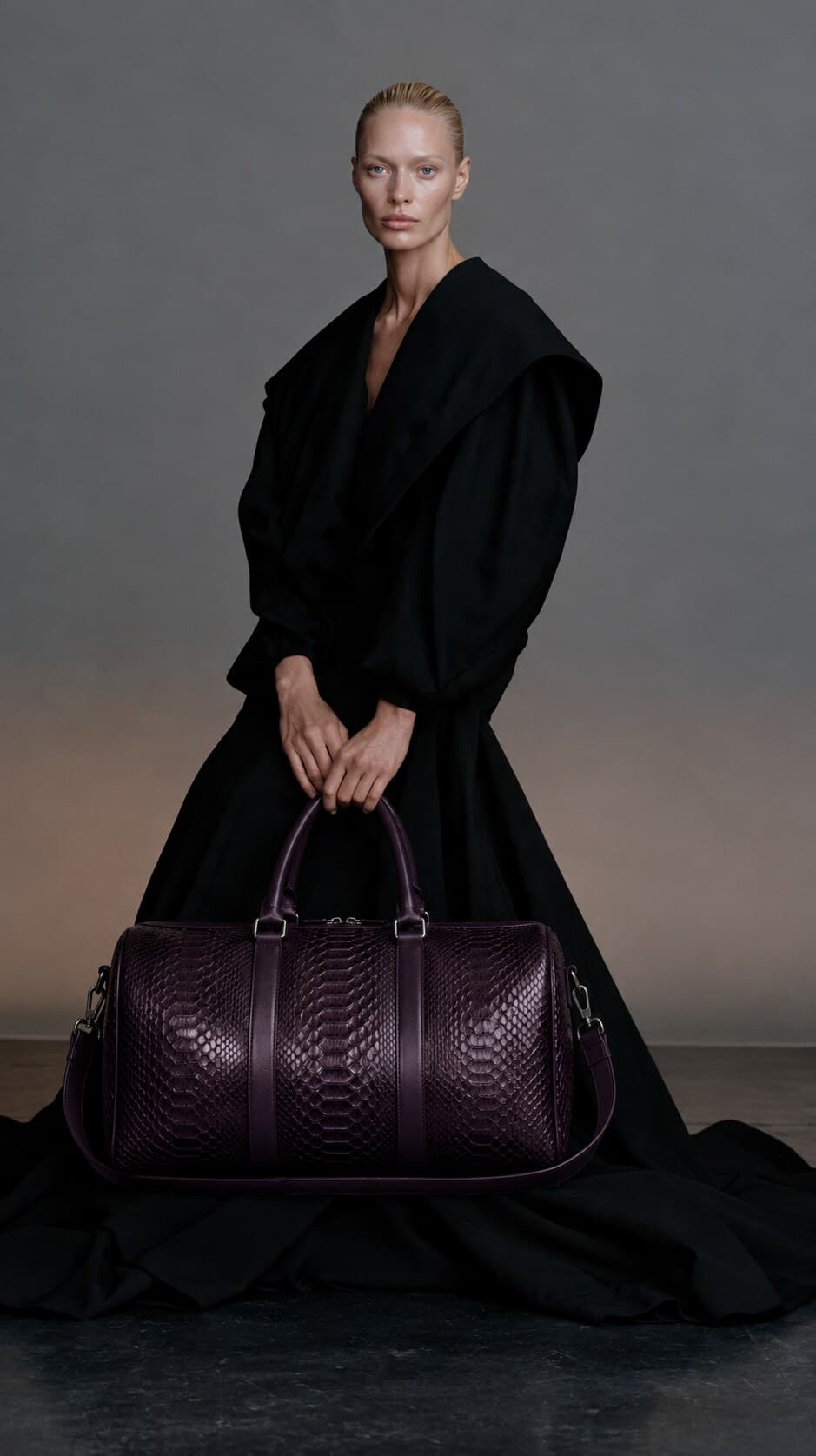 The Dom Bag in Plum, carried