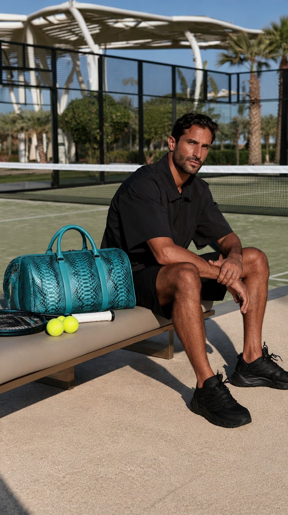 The Dom Bag in Turquoise, carried